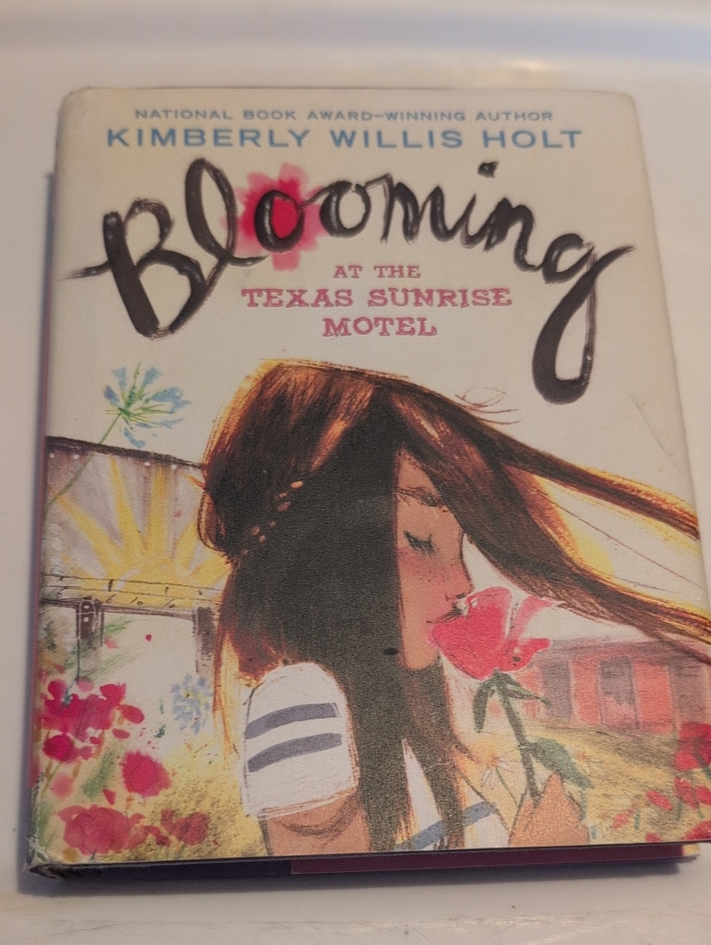 Blooming at the Texas Sunrise Motel Hardcover Book by Kimberly Willis Holt